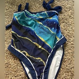 Women’s one piece swimsuit with matching sarong.